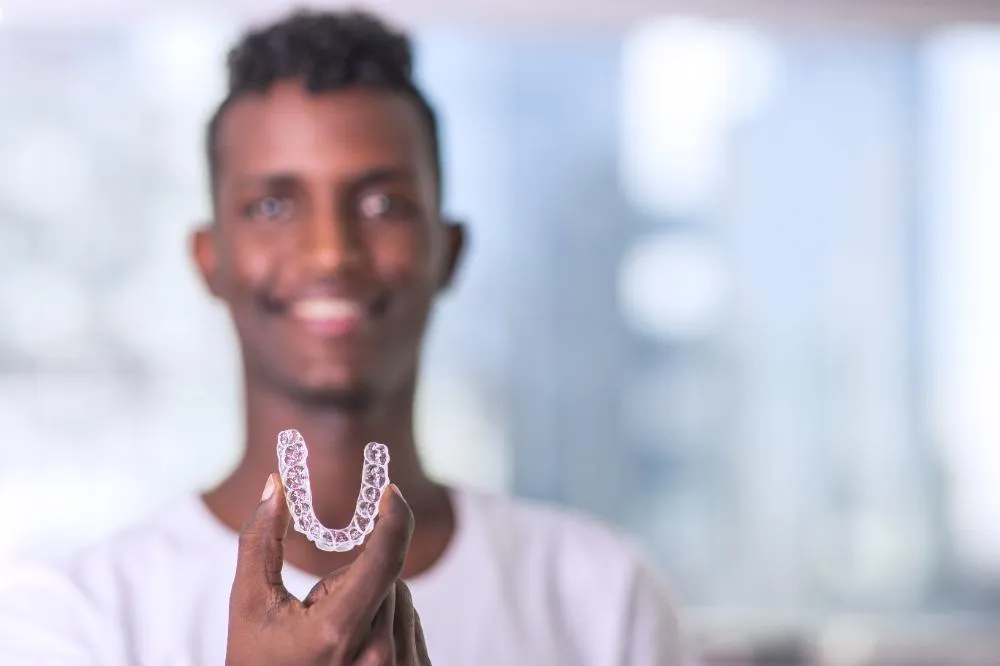 Handsome African Young Man Is Holding An Invisalign